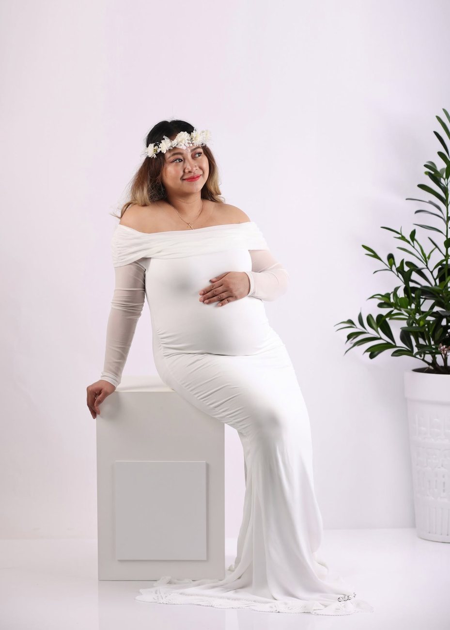 Studio maternity portrait in white